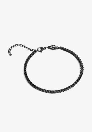 Must mustriga kaelakee keeratud ahelaga disainiga, kaelakese lukus on dekoratiivne liilia motiiv ja reguleeritav pikendusahel.