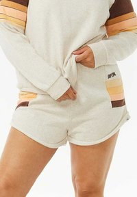 Sudadera gris claro y pantalones cortos a juego. Material suave y texturizado con acentos de rayas multicolores en marrón, naranja y amarillo. Cuenta con bolsillos laterales.