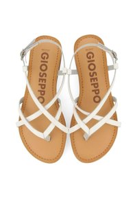 Sandali bianchi con cinturini incrociati, soletta in pelle e plantare beige. Presentano dettagli in argento e una fibbia per la regolazione.