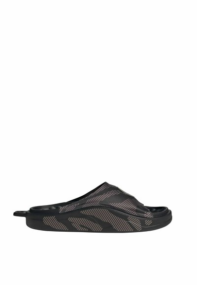 Black slide sandal featuring a textured upper with diagonal striping, a smooth sole, and a slight curve in the design for comfort.