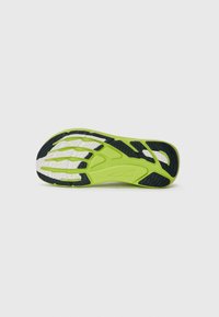 Green and black athletic shoe sole with a textured, flexible design; features a white accent and patterned grooves for traction.