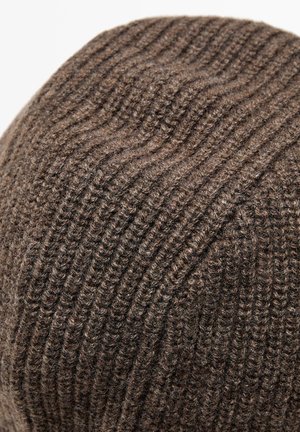 Close-up of brown knitted wool fabric with ribbed texture and visible knitting pattern.