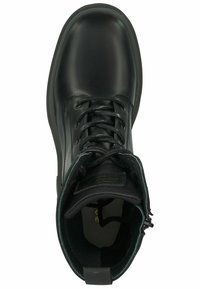 Black leather ankle boot with rounded toe, lace-up front, padded collar, and logo detail on tongue. Textured interior lining and heel tab.