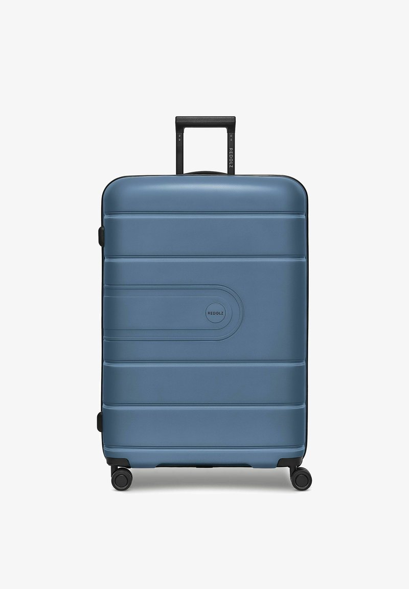Valise rigide bleue avec quatre roues multidirectionnelles et une poignée télescopique noire, nom de marque "REDOLZ" visible à l'avant et sur la poignée.