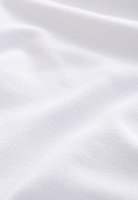 Tejido blanco texturizado, con un fino patrón entrelazado. Superficie lisa con un sutil brillo; se drapea suavemente con pliegues suaves.