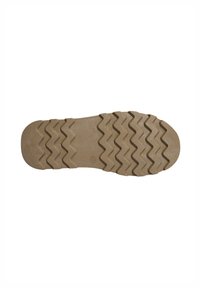 Suela de goma con patrón de tracción en zigzag, que presenta una punta redondeada y una superficie texturizada. El color es marrón claro con un acabado suave.