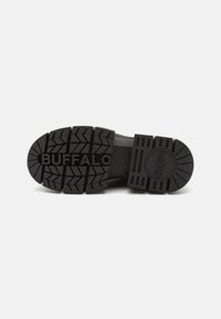 Black rubber sole with deep tread and “BUFFALO” embossed. Features a circular logo and textured accents for grip and durability.