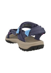 Purple and gray sandal featuring adjustable straps, a cushioned footbed, and a patterned black rubber sole. Blue and pink accents included.