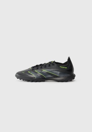 Black and gray soccer cleat with lime green accents, laces, and textured sole designed for turf or firm ground use.