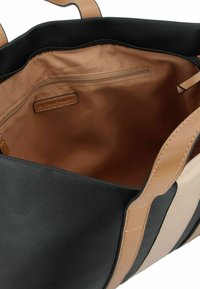 Borsa a spalla nera con manici e dettagli beige. L'interno presenta una tasca con zip e una fodera liscia color beige. Esterno texture.