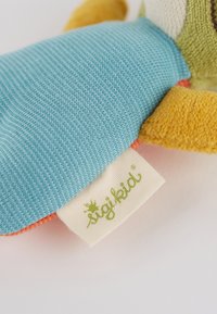 Soft plush toy with a textured yellow body, blue fabric limbs, and an orange accent. Features a white tag with green "sigikid" logo.