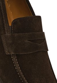 Dark brown suede loafer with a rounded toe, featuring a wide band across the front and contrasting stitching along the seams.