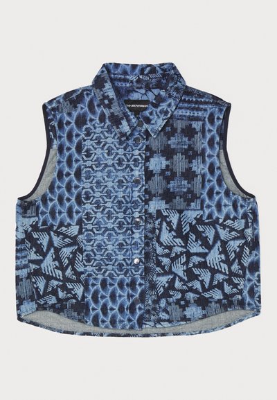 Denim sleeveless shirt featuring a patchwork design in various shades of blue, contrasting textures, and button closures.