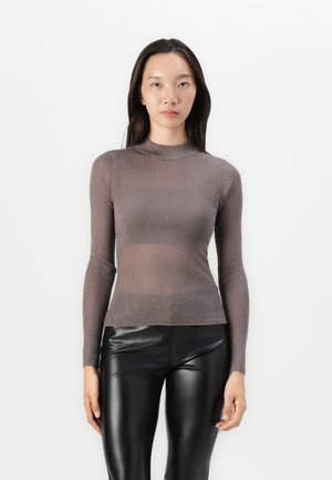 Brown ribbed long-sleeve top with a high neckline, paired with black shiny fitted pants, showcasing a slim silhouette and smooth texture.