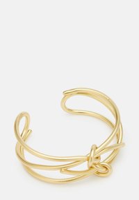 Bransoletka na nadgarstek w kolorze złotym, wykonana z metalu, z plecionym, gładkim wzorem, otwartymi końcami i detalem w postaci węzła w centralnej części.
