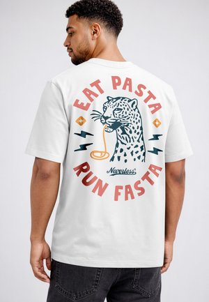 Man wearing white shirt with graphic of leopard eating pasta and text "Eat Pasta Run Fasta" on back.