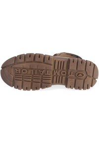 Brown rubber outsole with deep treads and pronounced grooves. Brand name "TAYLOR" embossed in the center, offering traction and durability.