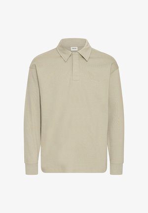 Long-sleeve polo shirt in light beige, featuring a collared neckline and a subtle texture. No visible logos or patterns.