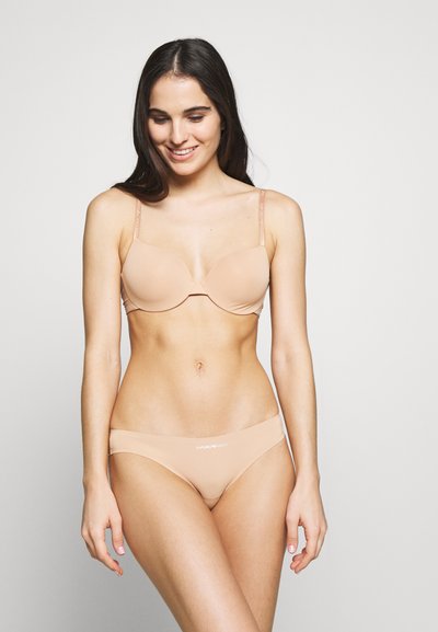 Light beige padded bra with adjustable straps and seamless design. Matching low-rise bikini bottom features a logo on the front waistband.