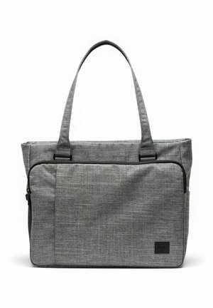 Sac cabas en tissu gris avec longues poignées, poche avant zippée et petite étiquette de marque noire dans le coin inférieur droit.