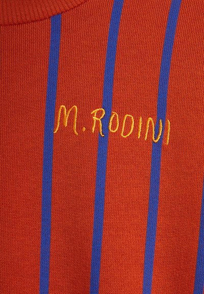 Suéter de punto naranja con dos rayas verticales azules y el texto bordado en amarillo "M. Rodini" en la parte frontal. El texto está ligeramente curvado.