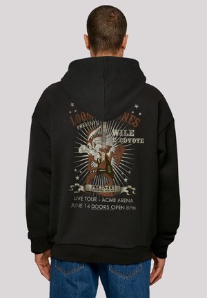 Sort hoodie med et retro-inspireret grafisk billede af Wile E. Coyote, der spiller guitar. Med detaljer som tekst og stjerneaccenter, samt tekstureret stof.