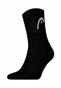 Svart ankelsocka gjord av ett slätt material, med en vit logotyp. Designen är enkel med en ribbad manschett och en sömlös tå.