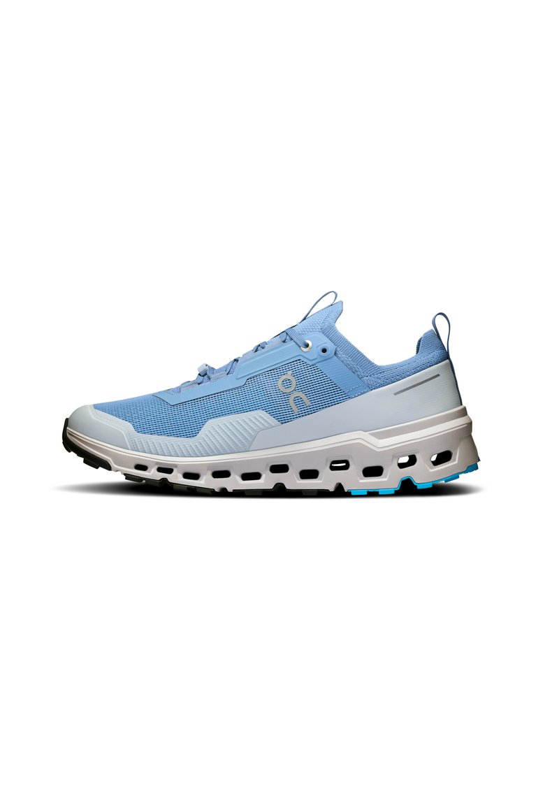 Light blue running shoe with a textured upper, reinforced toe cap, and a chunky white midsole. Features contrasting black outsole and blue accents.
