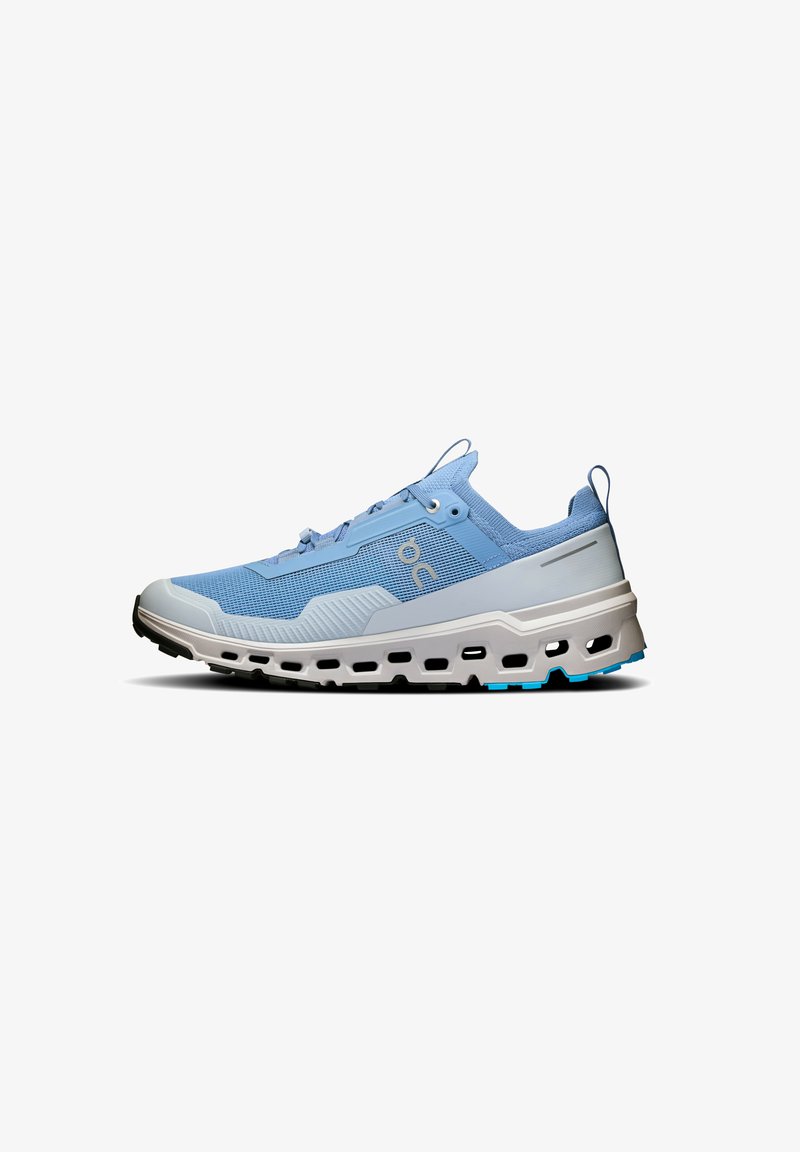 Light blue running shoe with a textured upper, reinforced toe cap, and a chunky white midsole. Features contrasting black outsole and blue accents.