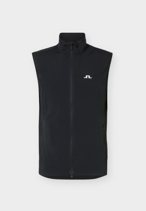 Svart ermeløs vest med glidelås foran og høy krage, med en liten hvit logo på venstre bryst.