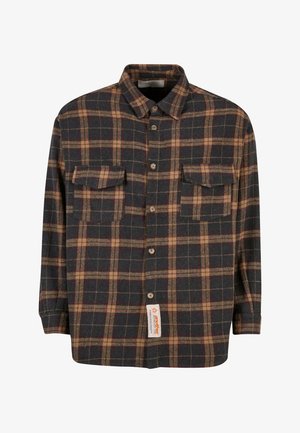 Tume mere jaamaga flanellär, millel on pruunid ja kreemjad ruudud, kahte rinna-taskut, nööbiga lukustus ja silt alaosas.