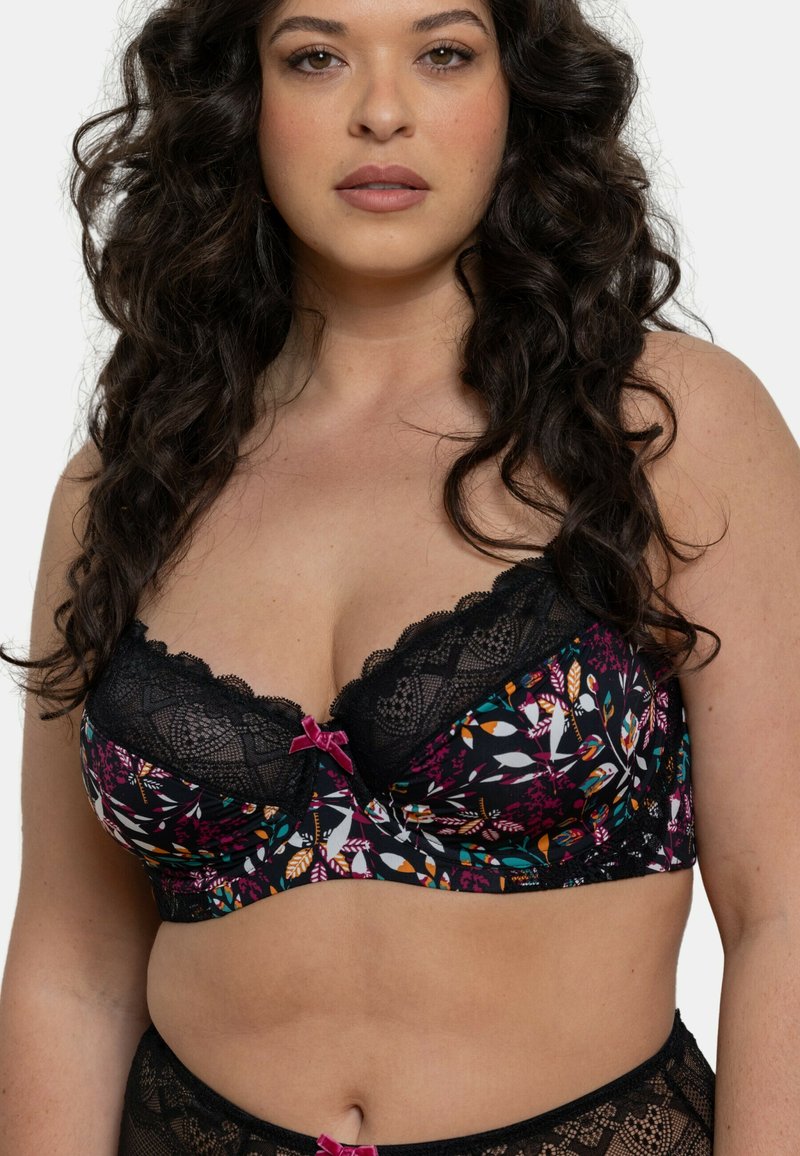 Soutien-gorge en dentelle noire avec imprimé floral présentant des couleurs vives, des bords festonnés et un petit nœud rose au centre.