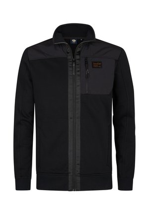 Chaqueta negra de cremallera con panel en contraste negro en los hombros y bolsillo en el pecho. Cuenta con puños y dobladillo de canalé, fabricada con material suave.