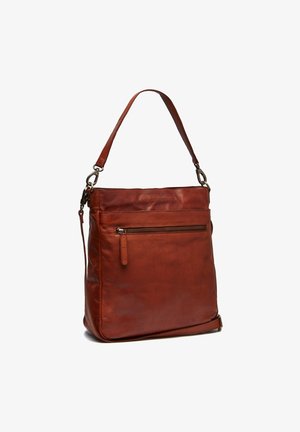 Leather shoulder bag in deep rust color, featuring a zippered front pocket and an adjustable strap. Smooth texture with minimalistic design.