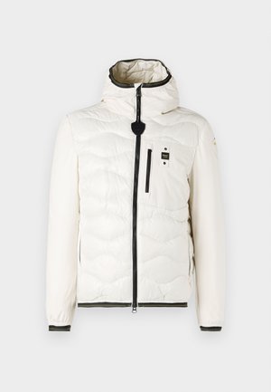 Valge puhv jacket, millel on tikkimise muster, kapuuts, esine tõmblukk ja mustad aktsendid tõmbluku ja mansettide juures. Sisaldab rinna taskut.