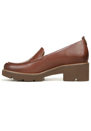Brown leather slip-on shoe with a rounded toe, elevated block heel, and textured sole. Features subtle stitching and sleek design.