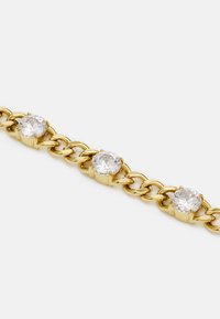 Gold chain bracelet featuring three embedded clear rhinestones, each held in a sleek setting, with interlinked oval chain design.