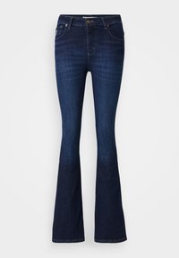 Mörkblå utsvängda jeans i denim med vanlig midja, fem fickor och diskret blekning på låren, med en rak ben-silhuett.