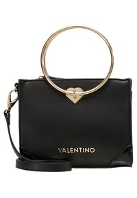 Svart läderhandväska med en strukturerad design, guldhardware, cirkulärt handtag och ett hjärtformat detalj. Innehåller en avtagbar axelrem.