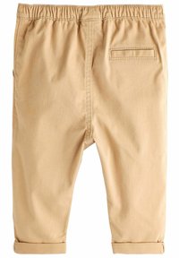 Pantalons en coton beige avec une taille élastique, des poignets roulés et une poche arrière unique. Texture lisse et coupe ajustée pour un maximum de confort.