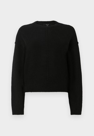 Pull court noir avec manches longues, col rond et tissu texturé. Comprend une couture centrale et des poignets et un ourlet côtelés.