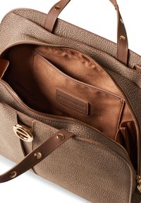 Brown textured bag with a smooth leather base, gold hardware, dual handles, and a spacious interior featuring a zip pocket and label.