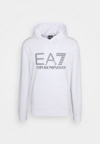 Bílá mikina s klokaní kapsou vpředu, s kapucí na stahování a tištěným logem EA7 Emporio Armani v šedé barvě na hrudi. Měkký materiál.