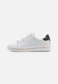 White leather sneaker with gold-tone eyelets, a textured black heel accent, and a thick white sole with a subtle gold stripe.
