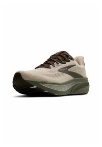 Baskets de course beige avec un dessus en tricot texturé, lacets marron foncé et une semelle intermédiaire verte. Présente un branding subtil sur le côté.