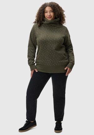 Olive green sweatshirt with a high collar, featuring white dot patterns and ribbed cuffs. Paired with black pants and black sneakers.