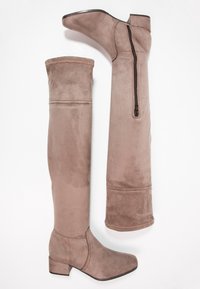 Braune Wildleder-Stiefel über dem Knie mit runder Spitze, Blockabsatz und seitlichem Reißverschluss für einfaches An- und Ausziehen. Glatte Textur und taillierte Passform.