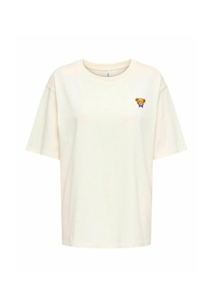Kremowa, oversize t-shirt wykonana z miękkiej bawełny, z małym haftem misia na lewej piersi z fioletową kokardą.