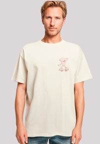 Short-sleeved cream t-shirt made from cotton, featuring a playful pink cartoon character on a skateboard. Loose fit with a round neckline.