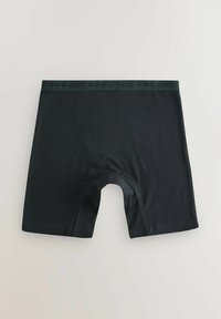 Boxer brev neri realizzati in un morbido tessuto elasticizzato. Presentano un colore uniforme con una cintura elastica brandizzata. Design casual e aderente.